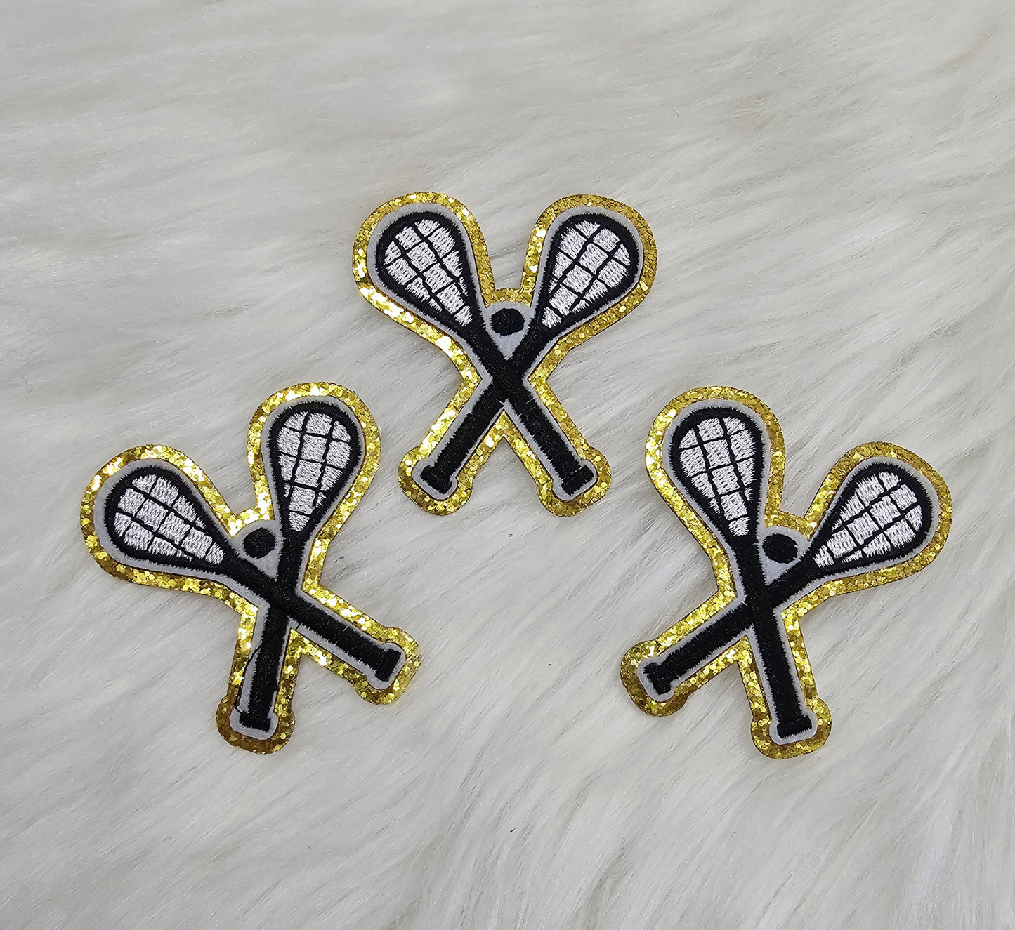 Crossed Lacross Sticks with Ball on Gold Glitter Iron On Patch